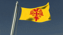 a yellow flag with a red cross on it
