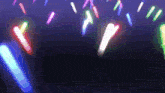 a bunch of glow in the dark sticks are flying in the air