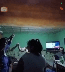a group of people are dancing in a room with a ome tv logo in the corner