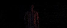 a pixelated image of a man standing in front of a curtain