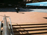 a skateboarder is doing a trick in front of a blue awning that says bayview