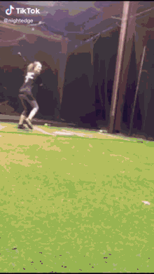 a person is swinging a bat on a baseball field