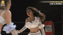 a woman with a bloody nose is in a wrestling ring with a sign that says caffeine