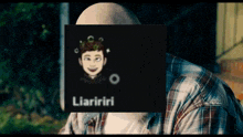 a man in a plaid shirt has a picture of a man behind a sign that says liariiri on it