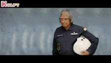a man in a military uniform is holding a white helmet in his hand