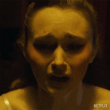 a close up of a woman 's face with her mouth open in a netflix advertisement .