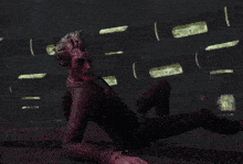 a man in a red suit is laying on the ground
