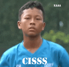 a boy in a blue shirt with the word cisss on it