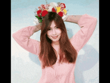 a woman in a pink shirt is wearing a flower crown