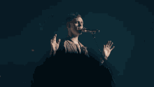 a man and a woman are singing into microphones in front of a crowd