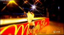 a woman is standing in front of a sign that says ' mrs. rudy ran ' on it