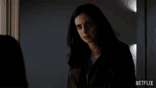 a netflix ad shows a woman standing in a doorway with the words come on behind her