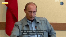 a man is sitting in front of a microphone and talking about cockroaches .