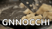 gnocchi is being cooked in a frying pan with a spatula