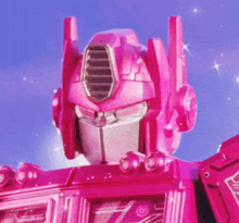 a close up of a pink robot with a blue sky in the background