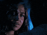 a close up of a woman 's face with a tear running down her cheek