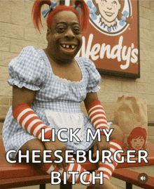 a wendy 's sign is behind a woman in a wendy 's costume