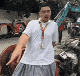 a man wearing a lanyard that says ' a ' on it is pointing at something