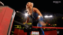 a woman in a wrestling ring with the word action on the bottom left