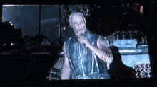 a man is singing into a microphone in a dark room .