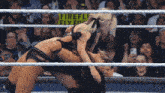 two women wrestling in front of a sign that says firefly fly for