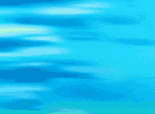 a cartoon girl with green hair is standing in front of a blue sky with her hand on her chin .