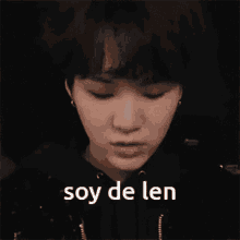 a close up of a person 's face with the words soy de len written below it