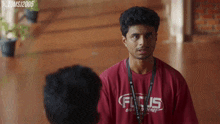 a man wearing a red shirt that says focus
