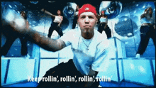 a man in a white shirt and red hat says keep rollin ' rollin ' rollin ' rollin ' rollin '