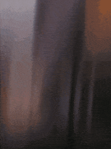 a blurry picture of a person 's face with a purple background