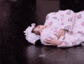 a person laying on the floor with the word uni on the bottom right