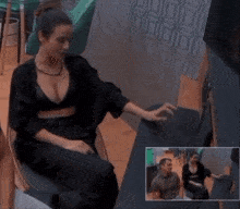 a woman in a black bra sits in a chair