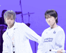a man wearing a white shirt that says prideless beyond