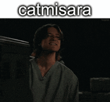 a man in a green scrub top is smiling with the name catmisara above him