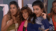 a group of women standing next to each other with nuestra tele written on the bottom of the screen