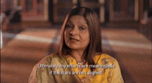 a woman in a yellow and green dress says ultimately my efforts are meaningless if the stars are not aligned .
