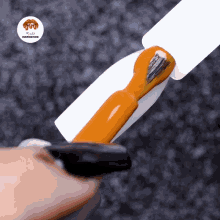 a close up of a nail with a brush and a sticker that says rude inspiration