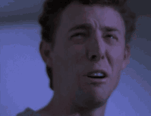a close up of a man 's face with his mouth wide open