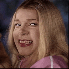 a close up of a woman making a funny face while smiling .