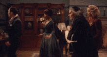 a blurry picture of a woman in a gold dress walking in a room