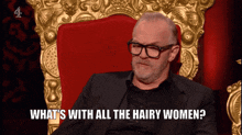 a man sitting in a chair with the words " what 's with all the hairy women " below him