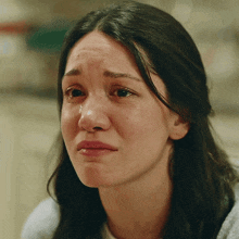 a close up of a woman 's face with tears running down her face