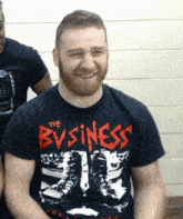 a man is wearing a black shirt that says the business