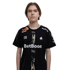 a young man is wearing a black t-shirt with a betboon logo on it .