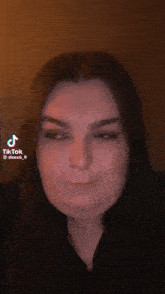 a woman is making a funny face in a tiktok video