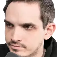 a close up of a man 's face with a microphone in his mouth