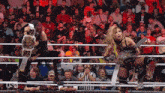 two women wrestling in front of a crowd with the hashtag #wweraw on the screen