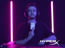 a man wearing headphones and holding a card with the words no you on the bottom