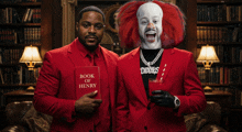 a man in a red suit is holding a book of henry