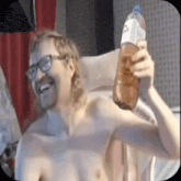 a shirtless man with glasses and a mustache is holding a bottle of water .
